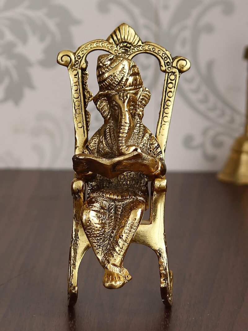 eCraftIndia Golden Metal Lord Ganesha Idol Reading Book On Rocking Chair - Decorative Hindu God Statue for Home Decor - Gift for Diwali, Housewarming - Ideal for Living Room, Office, Study Areas