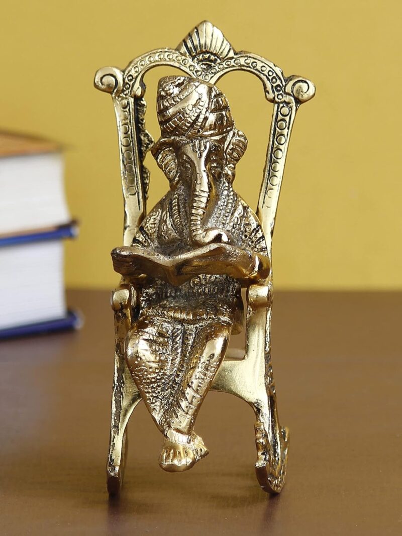 eCraftIndia Golden Metal Lord Ganesha Idol Reading Book On Rocking Chair - Decorative Hindu God Statue for Home Decor - Gift for Diwali, Housewarming - Ideal for Living Room, Office, Study Areas